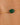 Gold bracelet with a green gemstone on a person's wrist