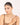 Woman wearing a necklace on a plain background