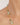 Gold necklace with green beads on a person's neck against a neutral background