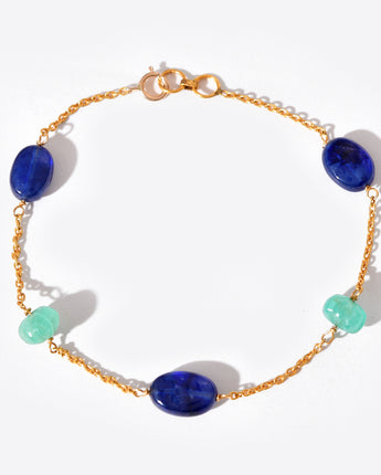 Bracelet with blue and green beads on a white background