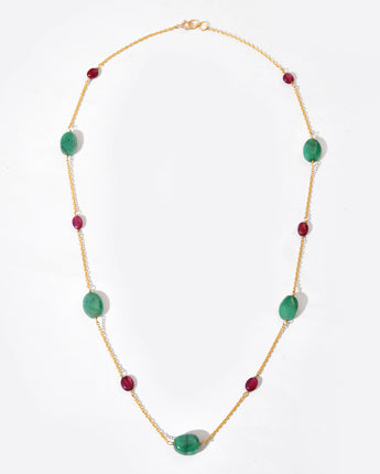 Necklace with green and red beads on a white background