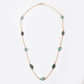 Necklace with green and pink beads on a white background