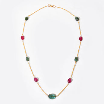Necklace with green and red beads on a white background