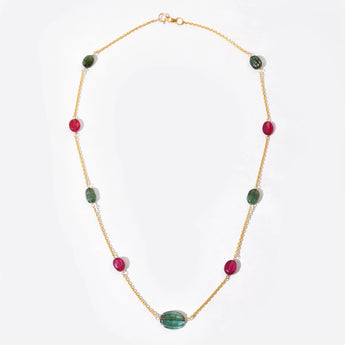 Necklace with green and red beads on a white background