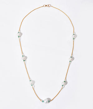 Pearl necklace with gold chain on a white background