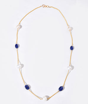 Necklace with blue and white beads on a white background
