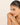 Woman wearing a bracelet on a beige background