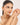 Woman wearing a bracelet on a plain background