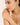 Woman wearing a delicate bracelet on a plain background