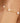 Gold bracelet with pearls on a wrist against a blurred background