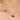 Gold necklace with purple gemstones and a pearl on a woman's neck