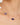 Gold necklace with purple gemstones and a pearl on a woman's neck