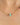 Gold chain necklace with green and pink beads on a woman's neck