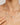 Pearl necklace with gold chain worn by a woman, close-up on neck and chest.