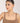 Woman wearing a necklace against a plain background