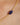 Gold chain necklace with a blue stone on a woman's neck