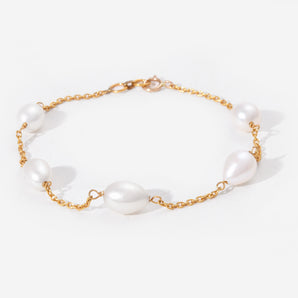 Pearl bracelet with gold chain on a white background
