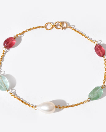 Gold bracelet with colorful beads on a white background