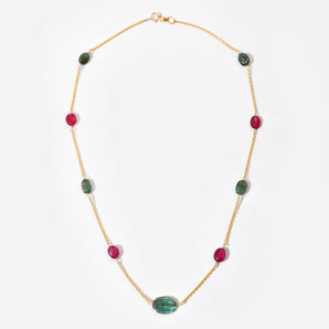 Necklace with green and red beads on a white background