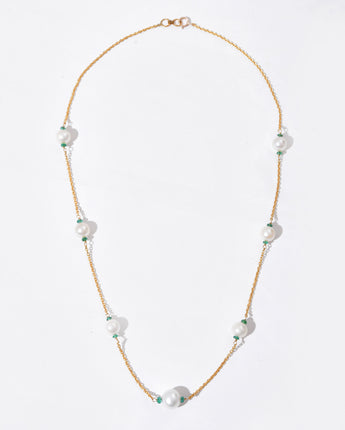 Pearl necklace with gold chain on a white background