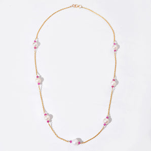 Necklace with pink and white beads on a light gray background